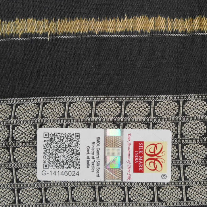 Close-up of the lustrous black Sambalpuri silk fabric, revealing its luxurious texture and fine weave.