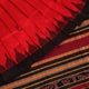 Textured close-up of red and black Sambalpuri Silk Saree fabric, highlighting the woven butta pattern.