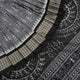 Close-up of grey & black Sambalpuri silk saree fabric, highlighting its rich texture and weave.