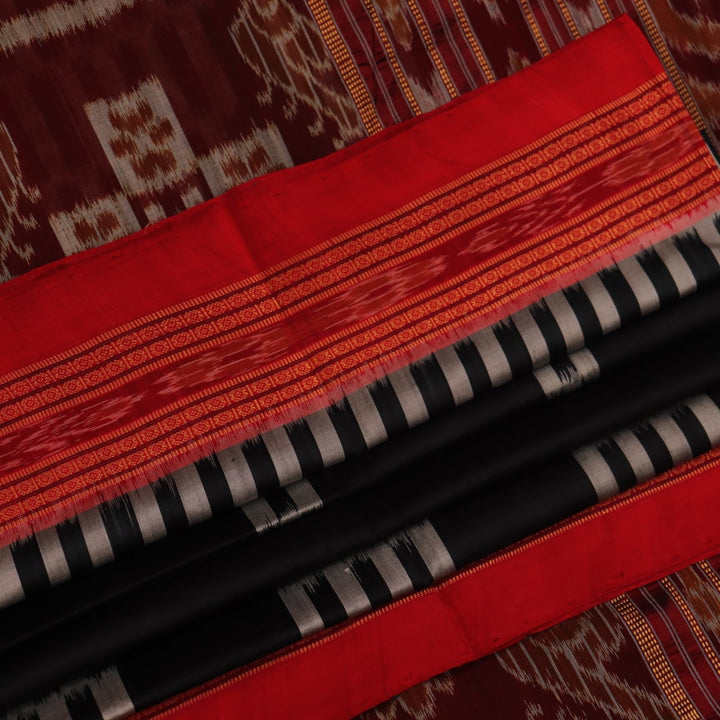 Khandua silk saree in black with red motifs, draped in a traditional style