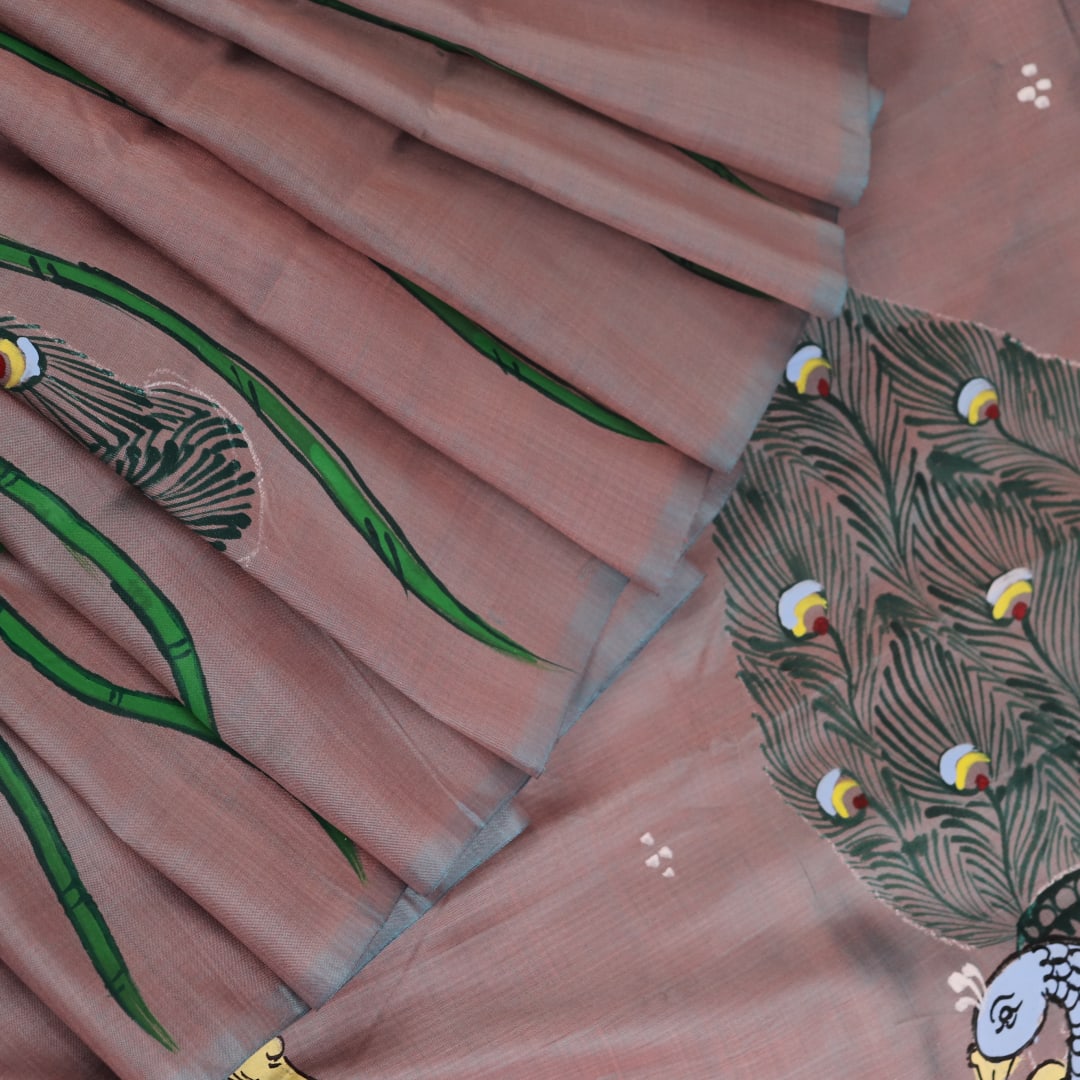 Close-up of hand-painted silk Patachitra saree fabric texture, showing the multicolor details and fine weave.