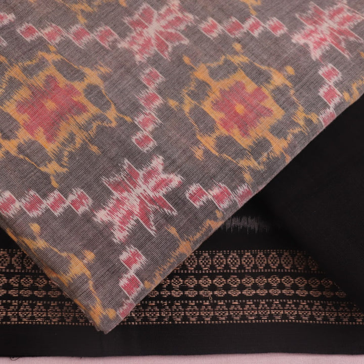 Close-up of Sambalpuri cotton dress material blouse piece in grey and black with motifs.