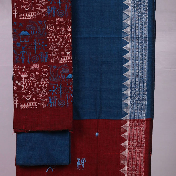 Close-up view of maroon and blue cotton Sambalpuri dress material, showcasing intricate doll pattern.