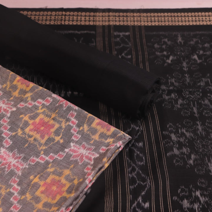 Close-up of Sambalpuri cotton dress material blouse piece in grey and black with motifs.