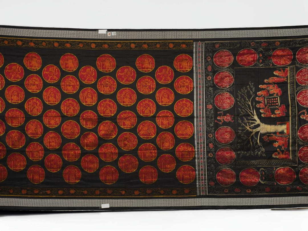 Close-up of the luxurious black Sambalpuri silk fabric, highlighting its rich texture and weave.