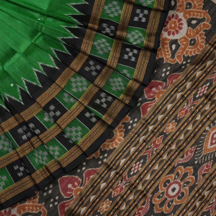 Model draped in a green and black Khandua silk saree with butta work, showcasing elegant ethnic styling.