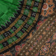Model draped in a green and black Khandua silk saree with butta work, showcasing elegant ethnic styling.