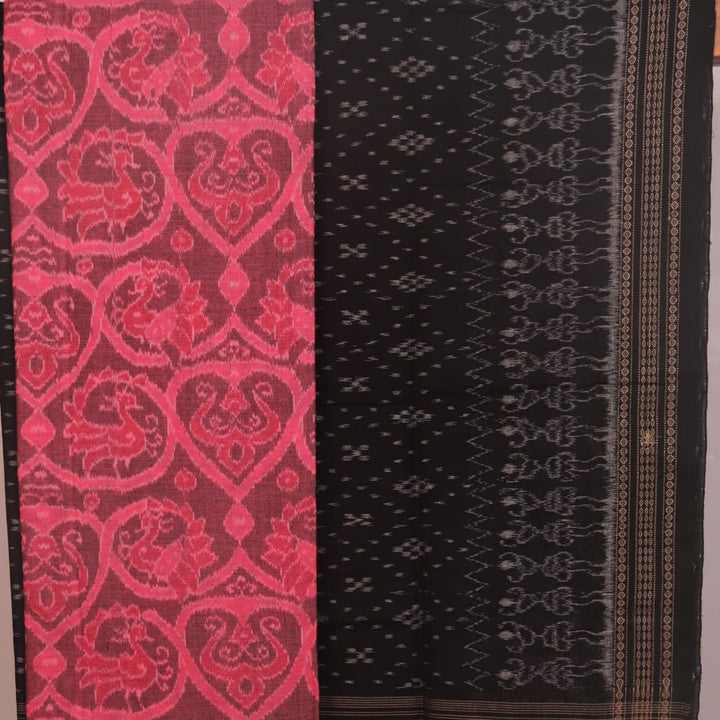 Detail of the pink and black Sambalpuri cotton dress material's blouse piece with motifs.