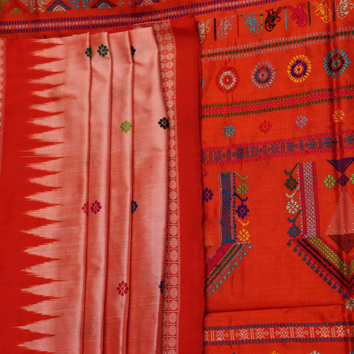 Close-up of finely woven silk fabric featuring intricate Butta patterns in multicolor with an orange accent