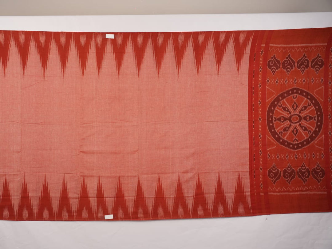 Professional styling view of a rust Sambalpuri cotton saree draped on a model for an elegant ethnic look.