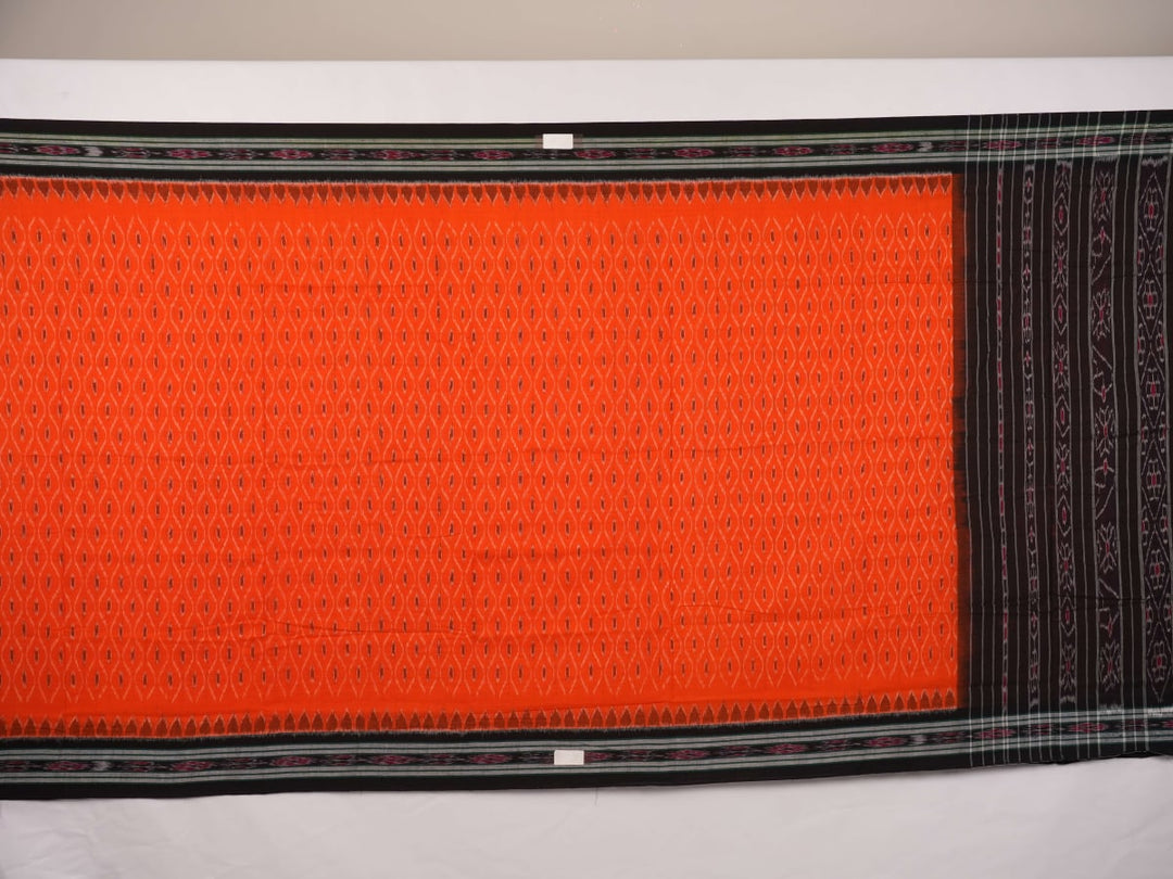 Model wearing an orange and black Sambalpuri cotton saree, styled in an elegant traditional drape.