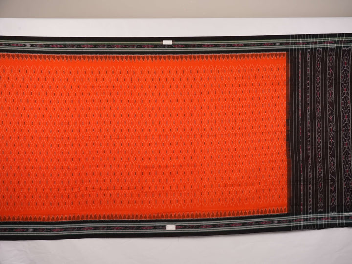 Model wearing an orange and black Sambalpuri cotton saree, styled in an elegant traditional drape.