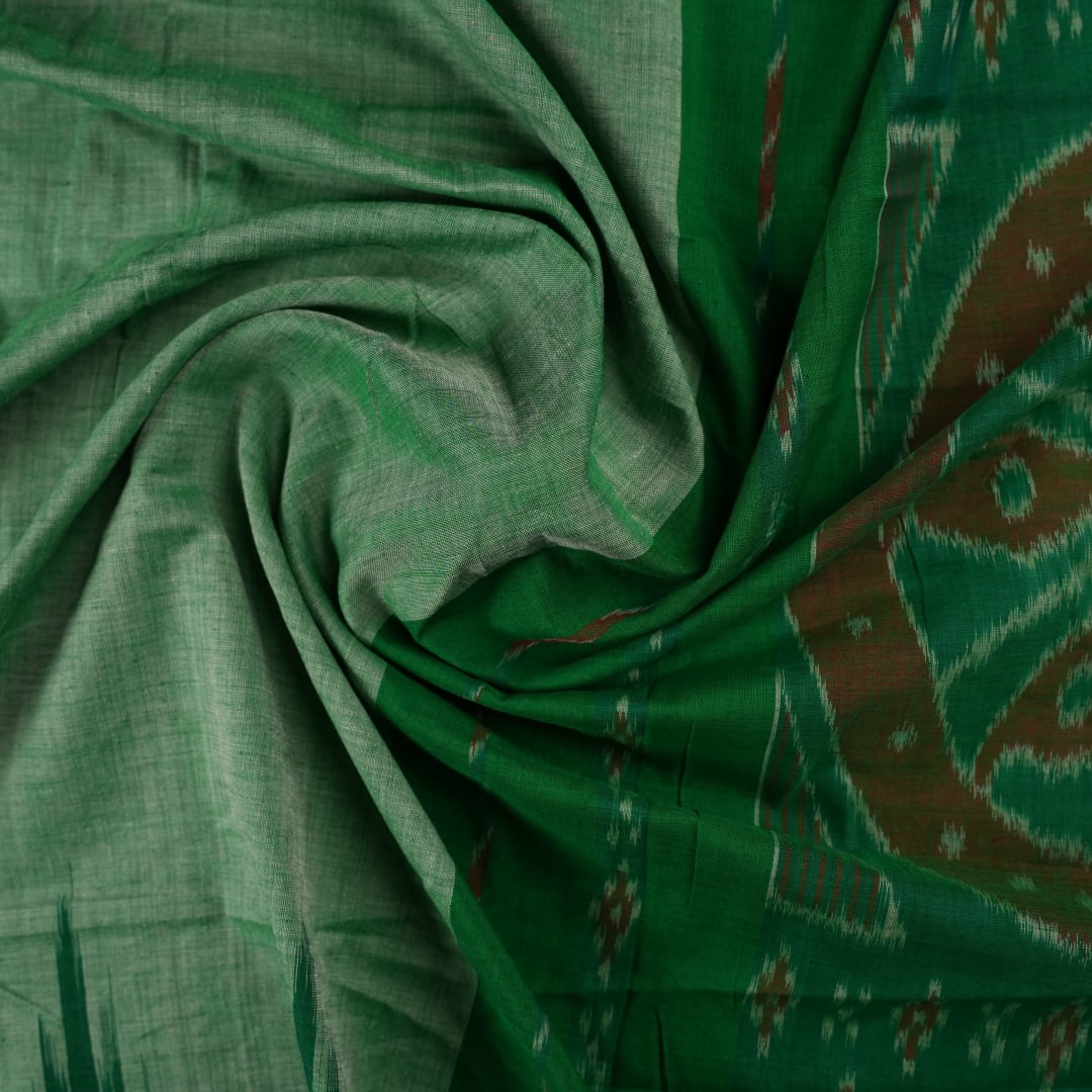 Model wearing a plain green Sambalpuri cotton saree styled elegantly to show the full handloom drape