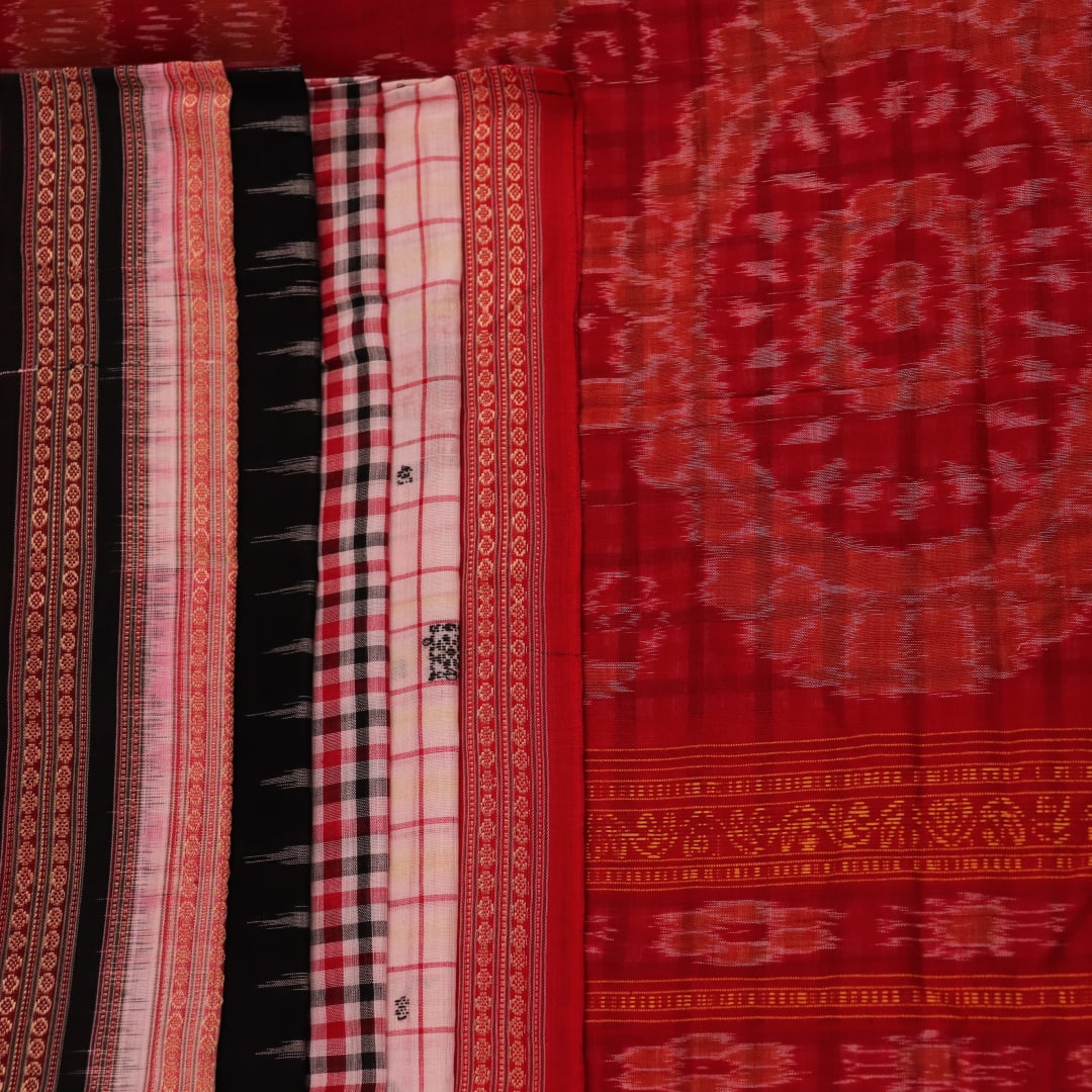 Full view of a multi-colored Bomkai cotton saree featuring a butta pattern with a red border.