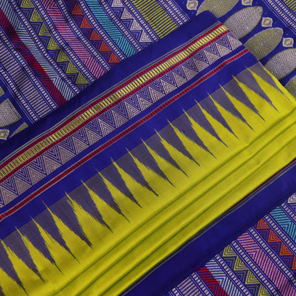Close-up of green and blue Dongria silk saree fabric texture with butta pattern.