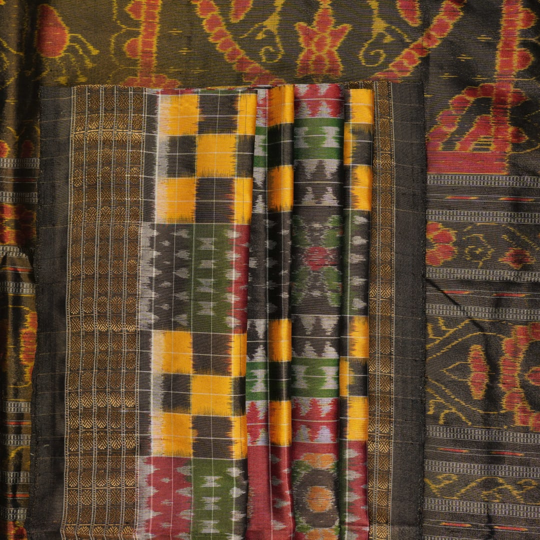 Extreme close-up of Sambalpuri Silk Saree fabric, revealing multi-color brown weave and tissue texture.