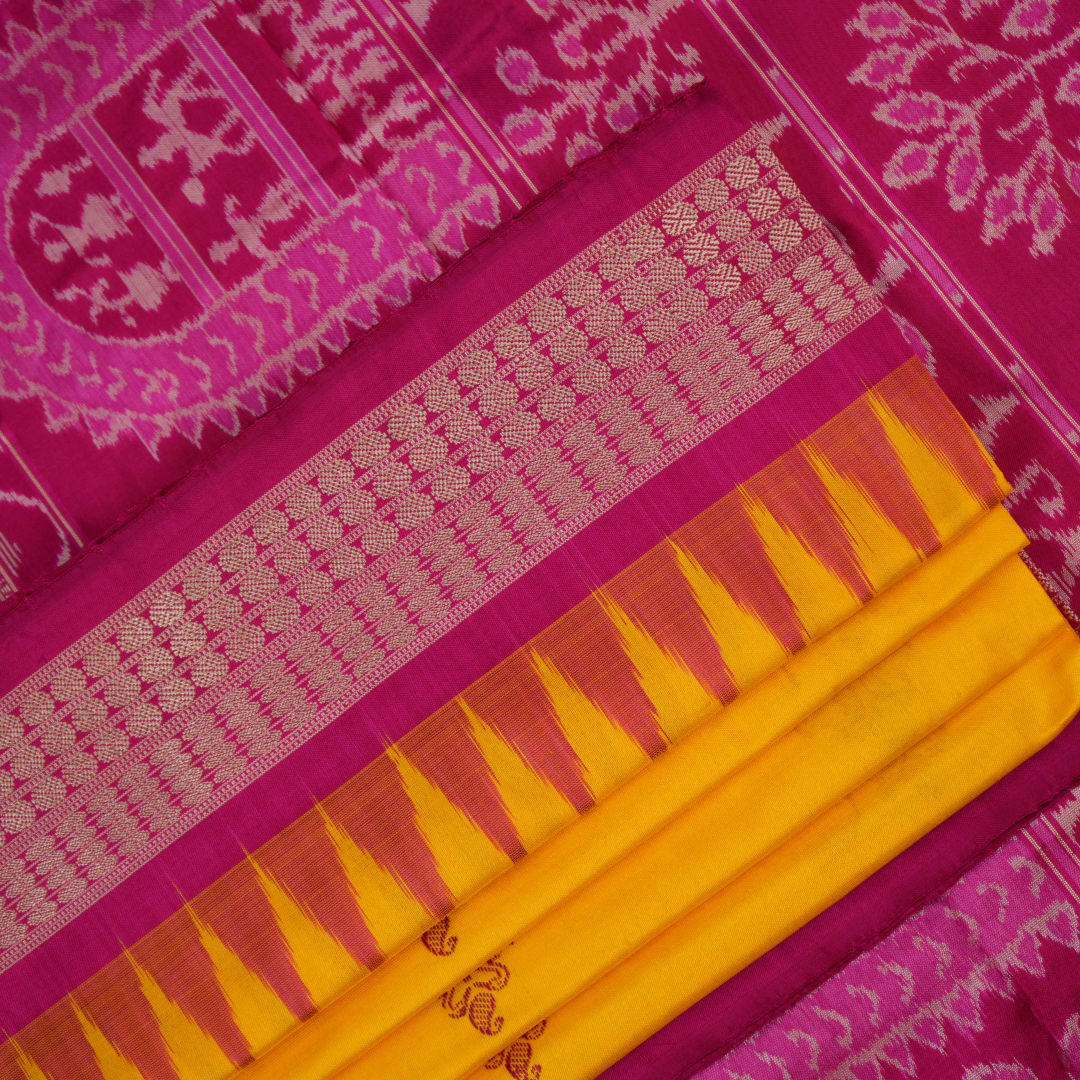 Close-up of the Bomkai Silk Saree's yellow fabric, revealing its luxurious texture and handloom weave.