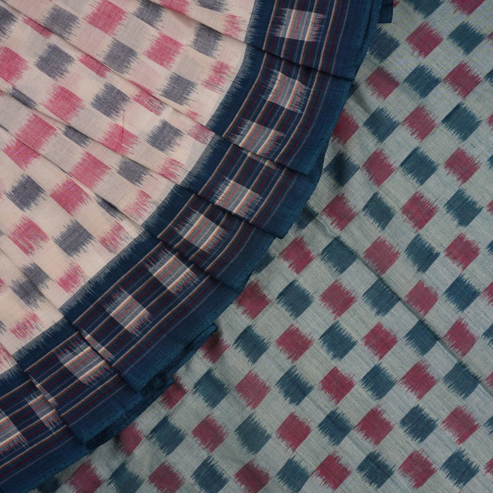 Styling view of a model draped in a white and blue Sambalpuri cotton saree with motif patterns