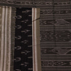 Saree styled; black Sambalpuri cotton saree with grey motifs showcased in a draped presentation.