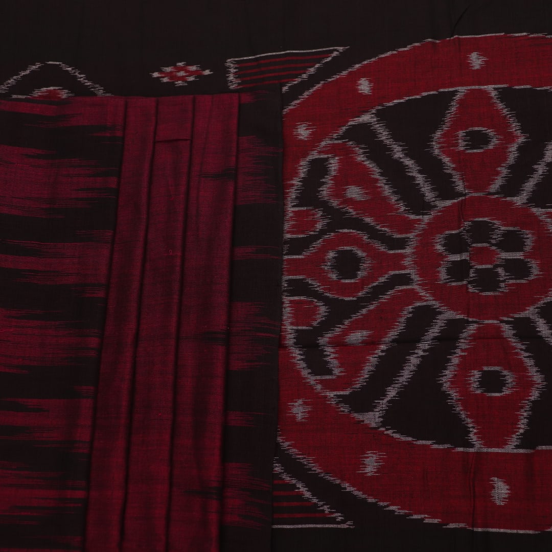 Plain maroon and black Sambalpuri cotton saree, elegantly draped.