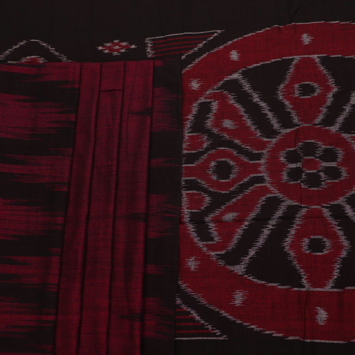 Plain maroon and black Sambalpuri cotton saree, elegantly draped.
