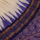 Woman elegantly draped in a white and blue Khandua silk saree with butta pattern.