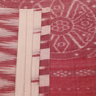 Model wearing a white and maroon Sambalpuri cotton saree with motifs, demonstrating a stylish drape.