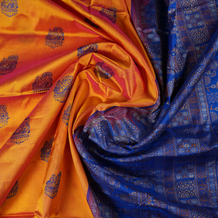 Close-up of Bomkai Silk Saree fabric texture and handloom weave in orange and blue threads.