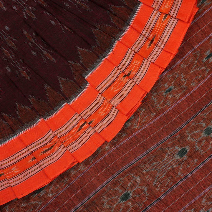 Model draped in a maroon and orange Sambalpuri cotton saree showcasing traditional handloom motifs.