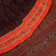 Model draped in a maroon and orange Sambalpuri cotton saree showcasing traditional handloom motifs.
