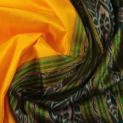 Yellow Khandua silk saree draped, showcasing its simple elegance and the plain body.