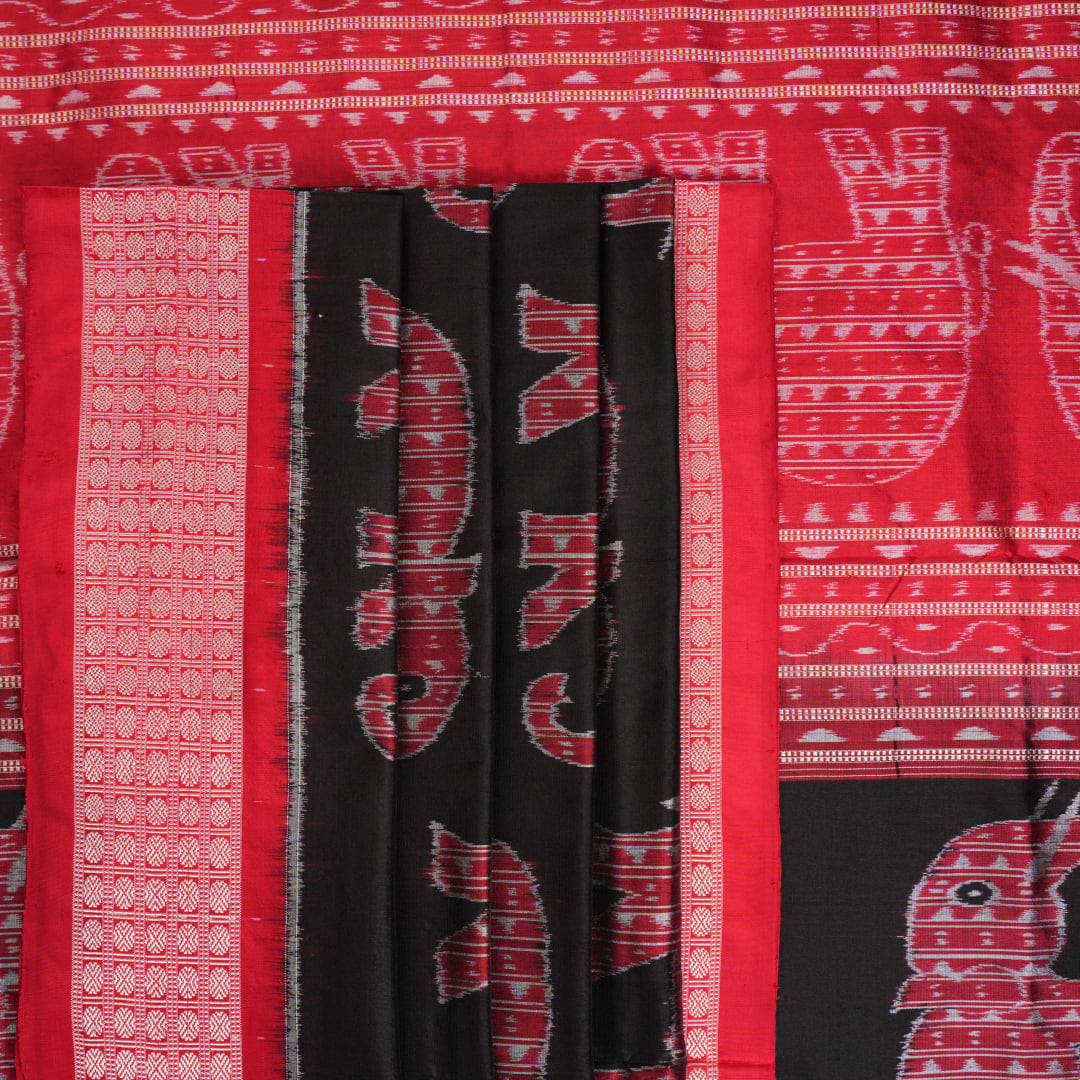 Close-up showing the luxurious texture and fine weave of the black Sambalpuri silk fabric.