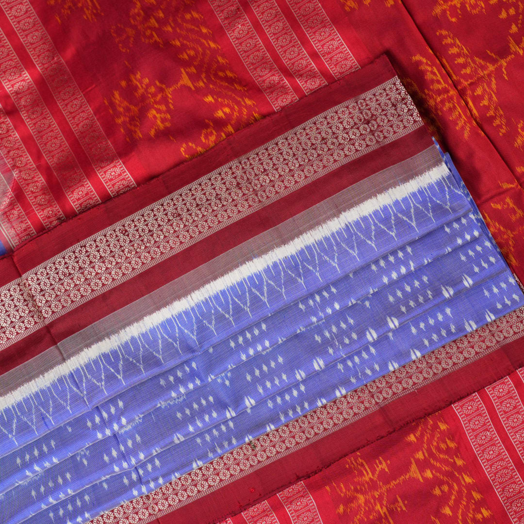 Close-up of the luxurious silk texture of the violet and maroon Sambalpuri Saree fabric.