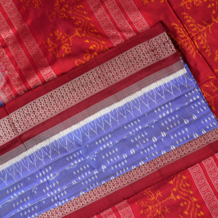 Close-up of the luxurious silk texture of the violet and maroon Sambalpuri Saree fabric.