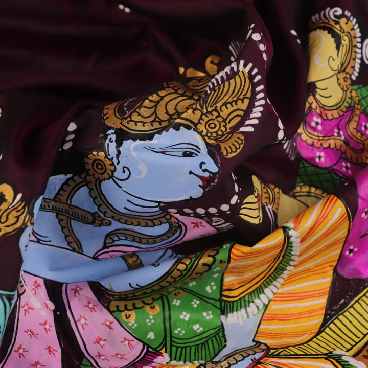 Close-up of a hand-painted silk Patachitra saree, highlighting the vibrant, textured weave and intricate details.