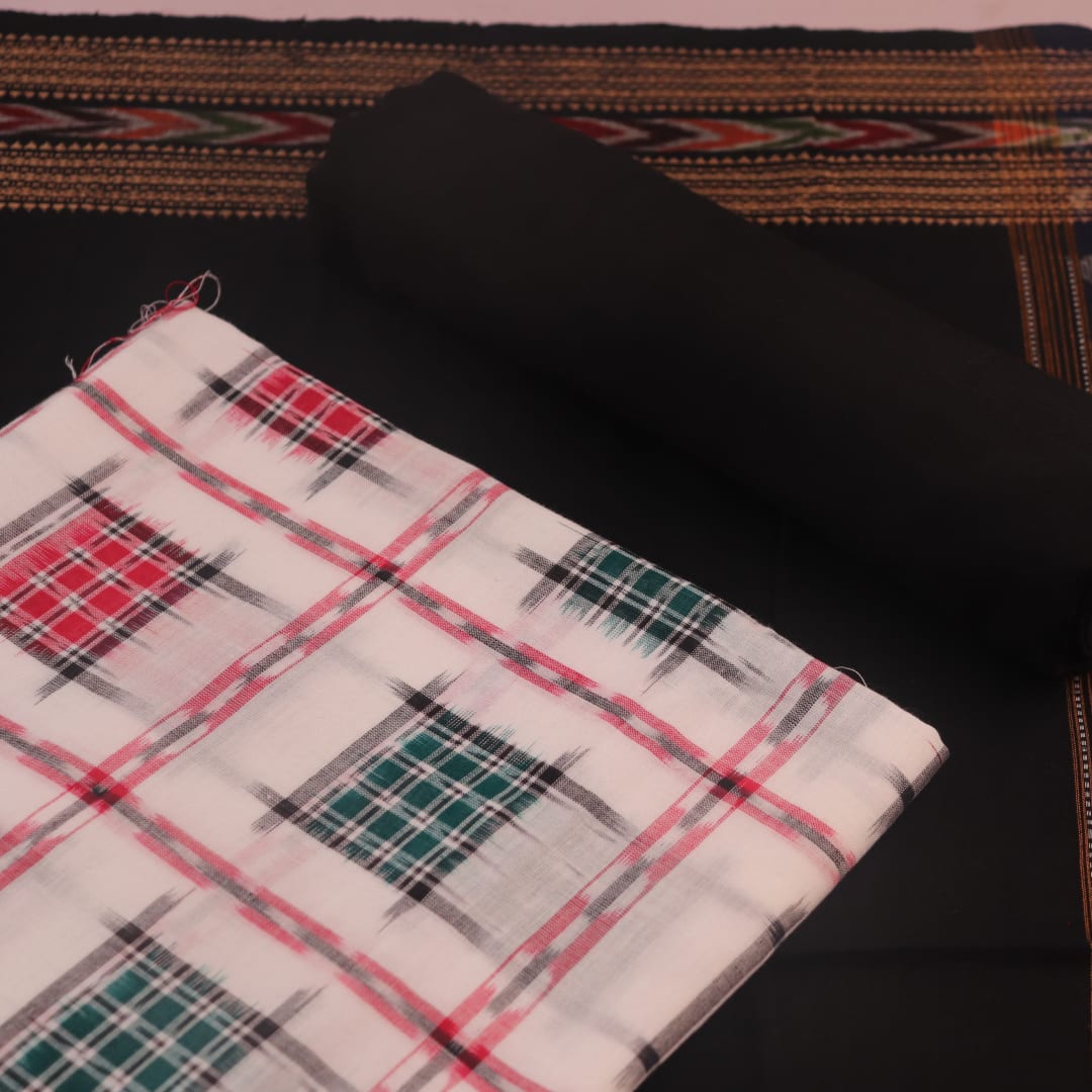 Detail of the motif-patterned blouse piece from a white and black Sambalpuri cotton dress material.