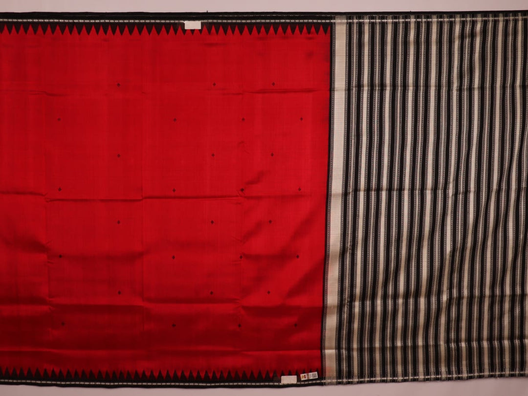 Close-up of the red and black plain silk fabric texture of a Berhampuri saree