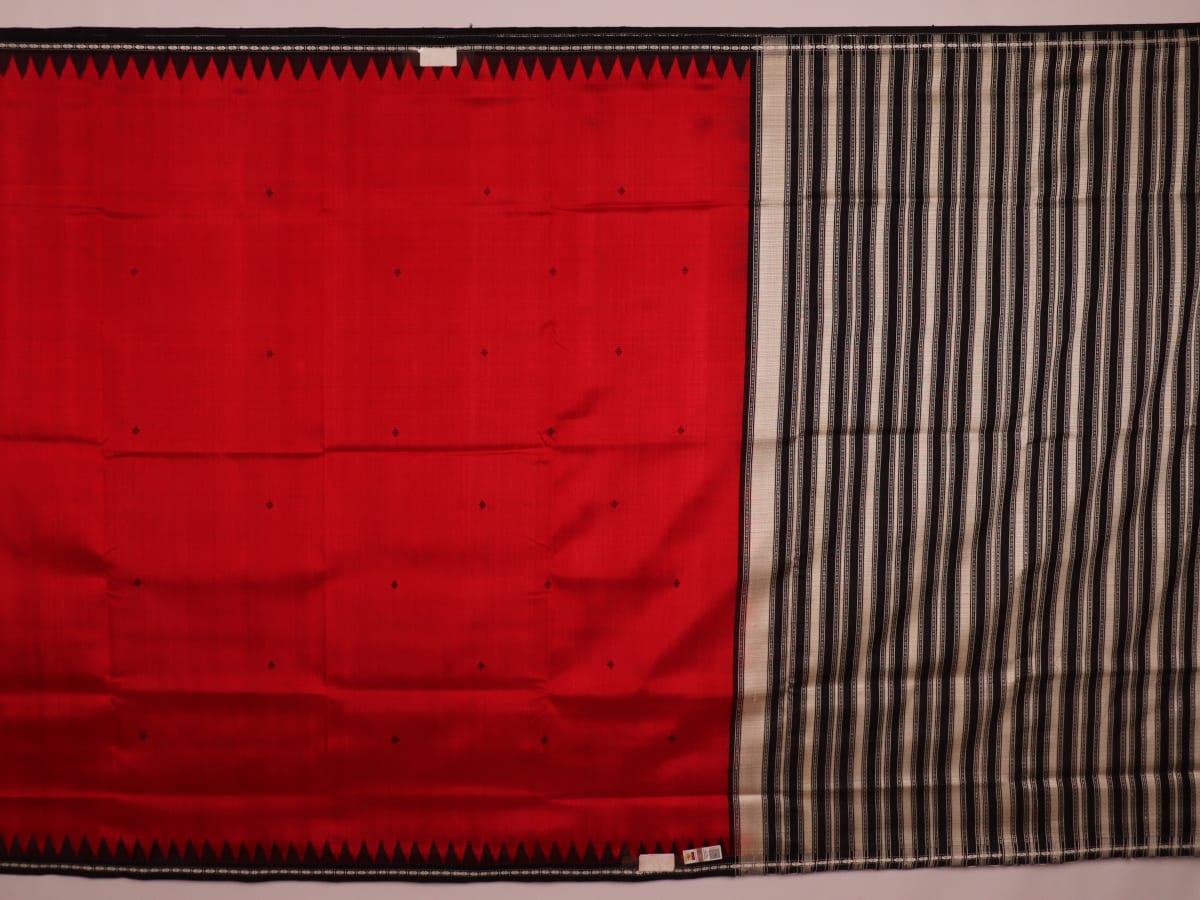 Close-up of the red and black plain silk fabric texture of a Berhampuri saree