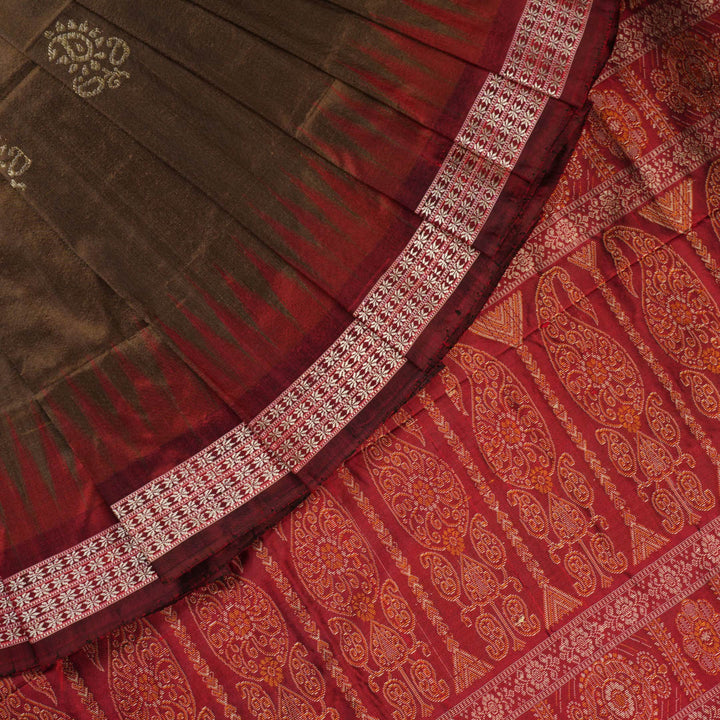 Close-up of Bomkai Silk Saree fabric, highlighting its luxurious brown silk texture and intricate weave.