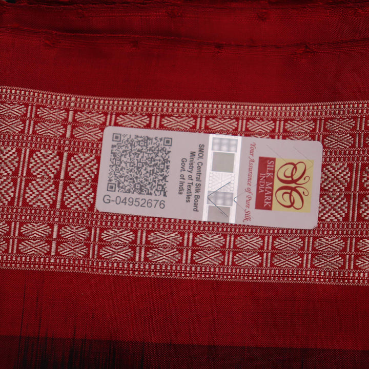 Close-up of black and red silk Sambalpuri saree fabric showcasing intricate motifs