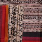 Close-up of off-white Tussar silk fabric, highlighting natural slubs and printed black pattern.