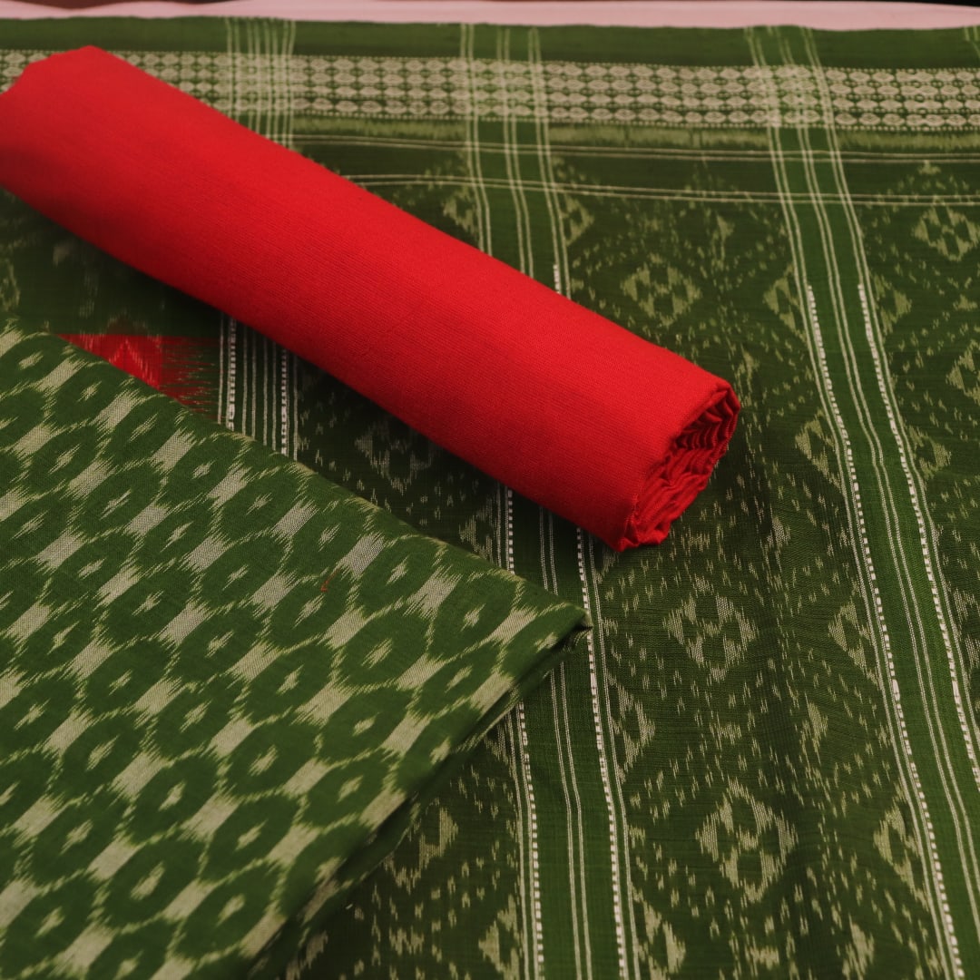 Close-up of the green Sambalpuri cotton dress material's blouse piece with red motifs.