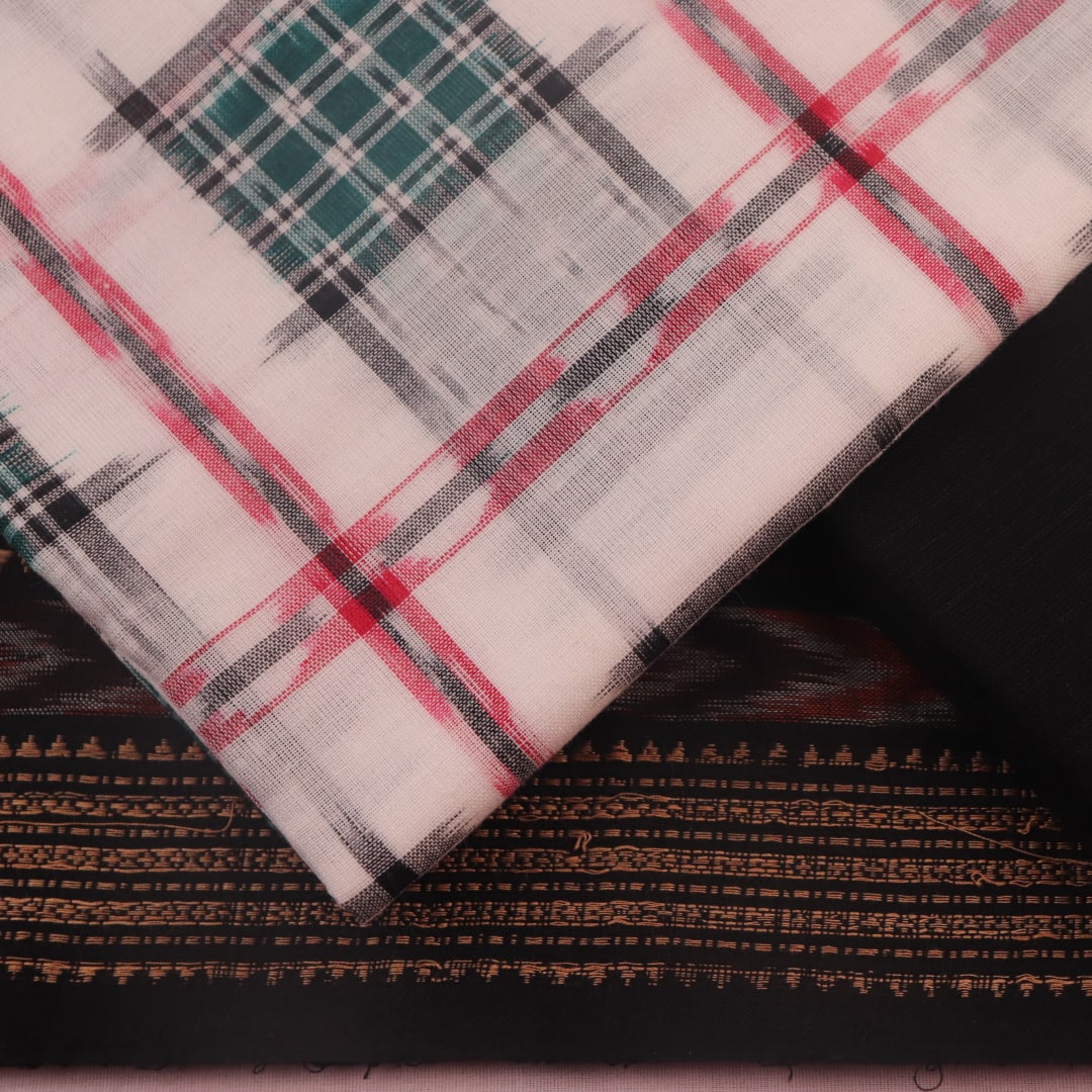 Detail of the motif-patterned blouse piece from a white and black Sambalpuri cotton dress material.