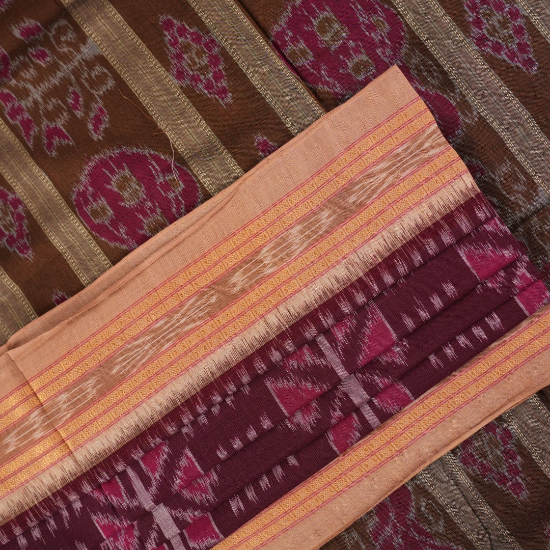 Model wearing an elegantly draped maroon and brown Sambalpuri cotton saree with traditional ikat motifs.