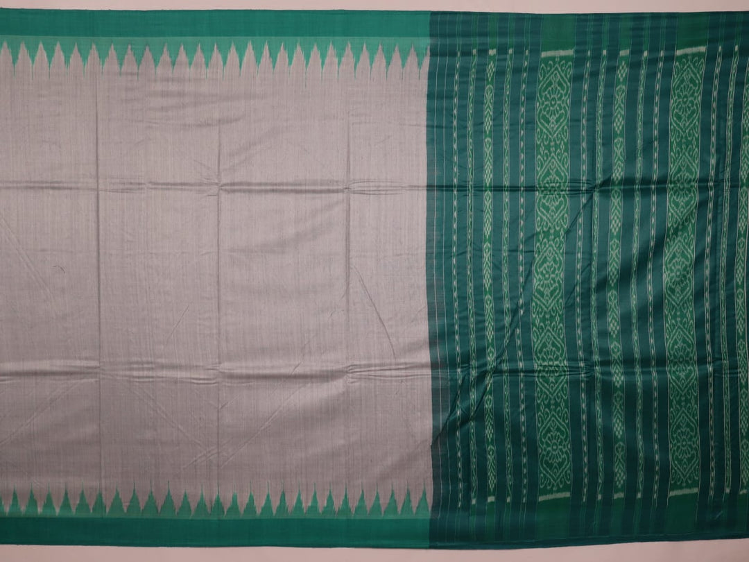 Close-up of textured grey and green Tussar silk fabric used in a plain pattern saree