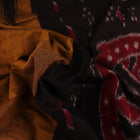 Brown and black plain Sambalpuri cotton saree styled, showcasing its elegant drape and subtle colors.