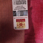 Close-up of maroon Tussar silk saree fabric, emphasizing its distinct texture and printed pattern.