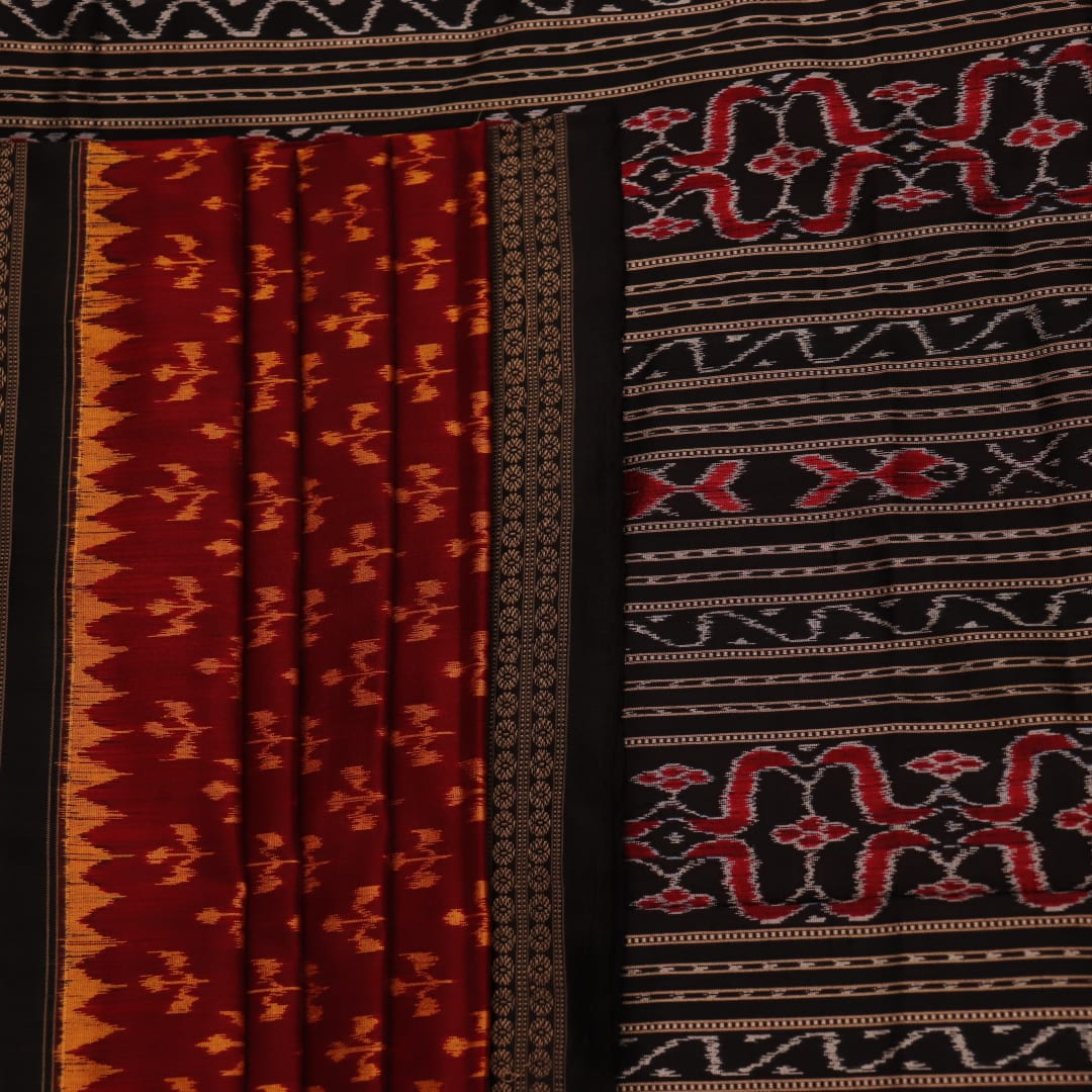 Close-up showing the fine silk texture and intricate motifs of the Sambalpuri saree