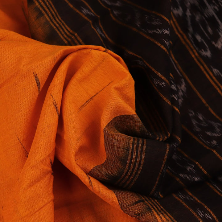 Draped view of a yellow and black Sambalpuri cotton saree with motifs, showcasing its styling and fall.