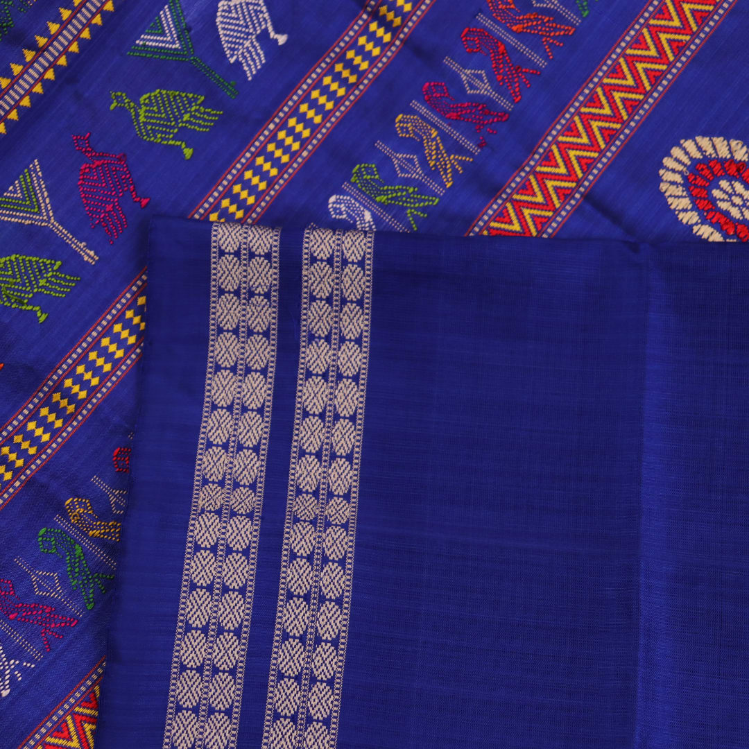 Close-up view of the vibrant orange and blue silk fabric texture with intricate butta pattern